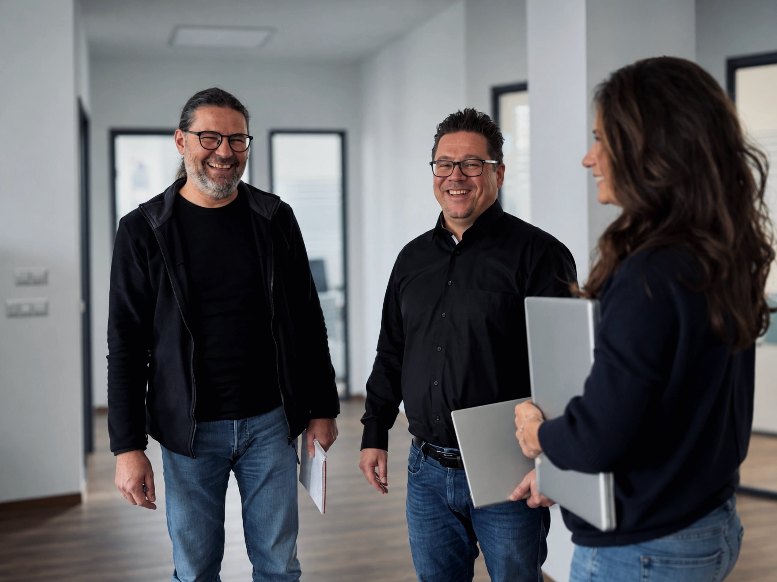 Three Warnow Design team members talking in the hallway